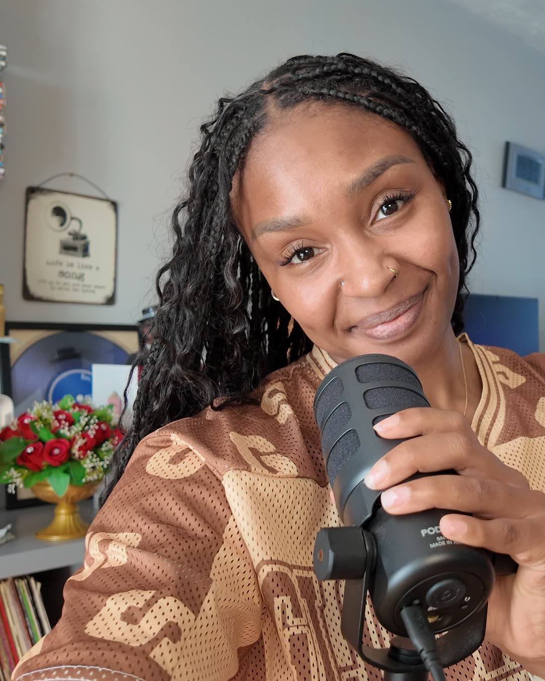 Shana Francis speaking into a podcast microphone in her studio